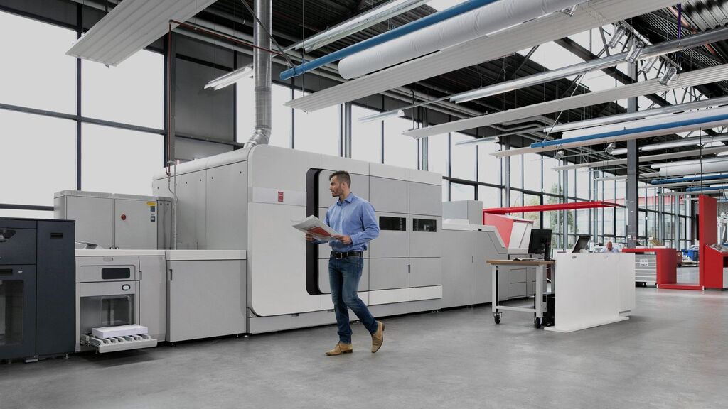 Medarbejdere ved Canon printer i moderne kontormiljø med professionel kopi, print og dokumenthåndtering